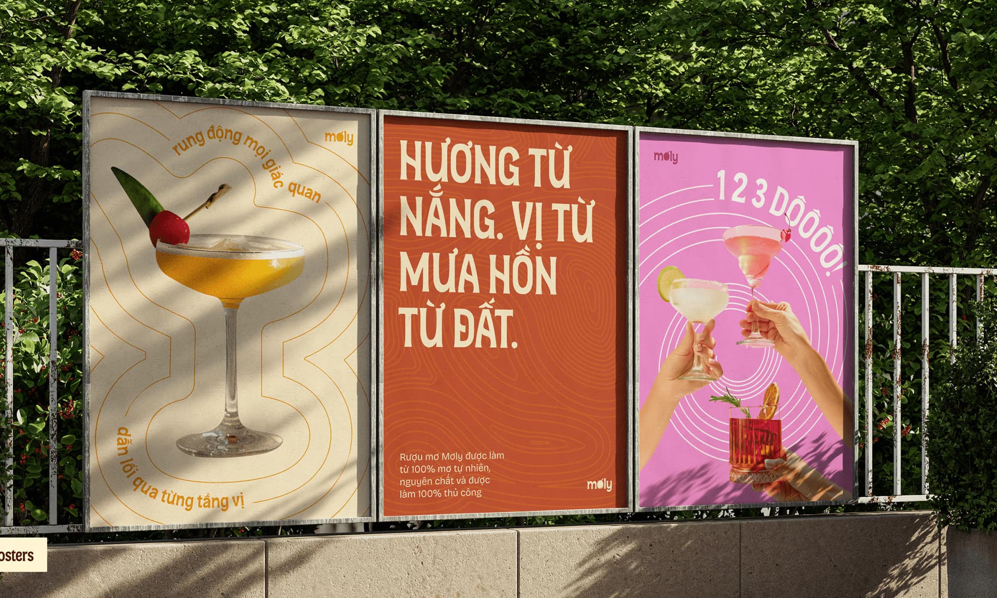 Colorful advertisement posters promoting cocktails, featuring vibrant drinks and enticing text in a lush outdoor setting.